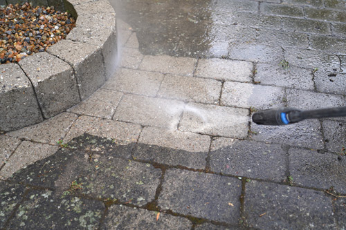 Picture of pressure washing paver walkway.