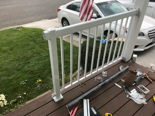 A picture of deck railing being put together.