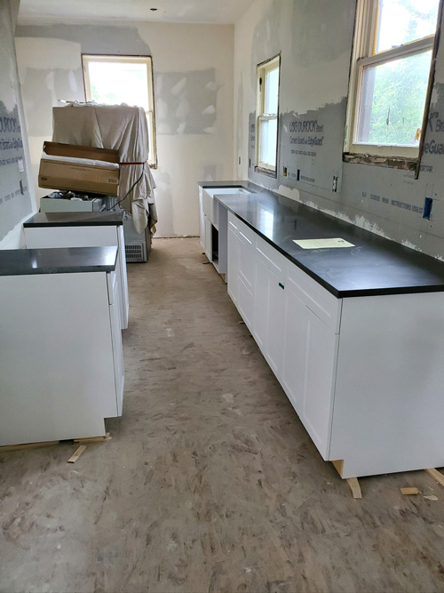 A picture of a kitchen remodel during cabinet and countertop installation.