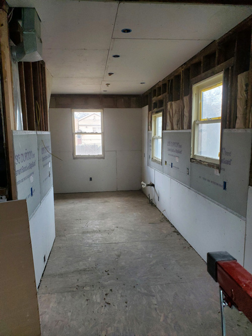 A picture of a kitchen remodel in drywall stage.