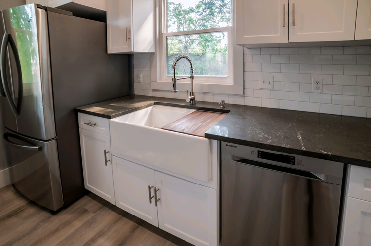 A after picture of a new sink, cabinets, and countertop.