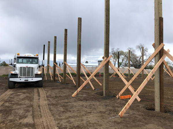 Airway Heights post frame building pouring concrete for post.