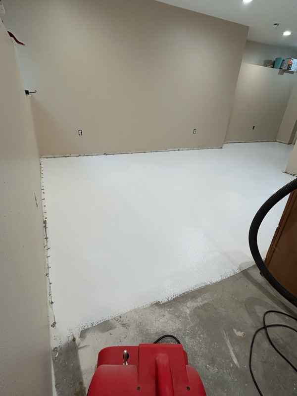 Basement in Northwood community being painted and having concrete floor sealed for new flooring.